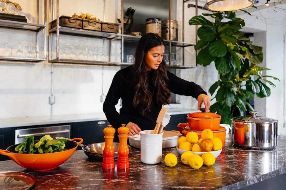 Woman preparing fresh lemons in a contemporary kitchen setting.
