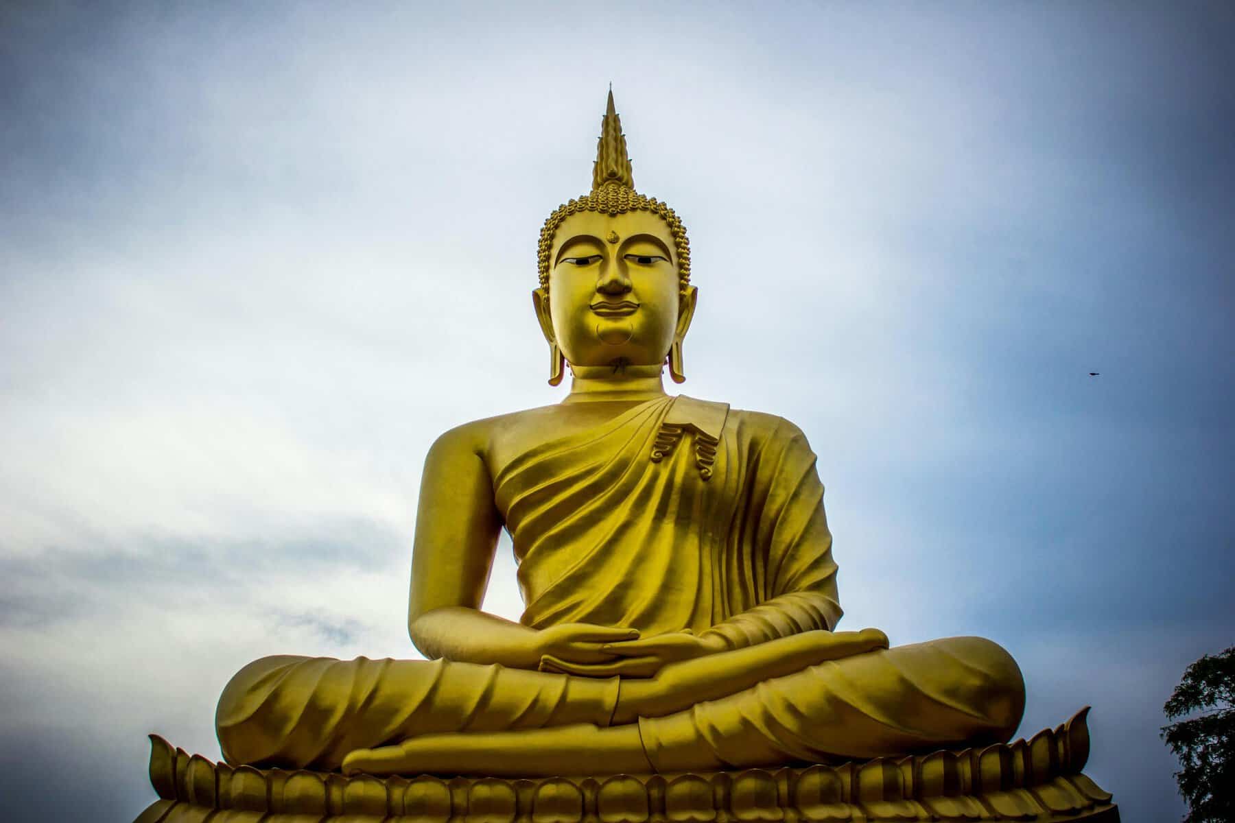 Golden Buddha statue, meditation, spiritual, Thailand, large outdoor sculpture.