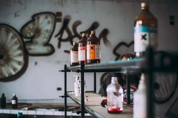 Chemicals and lab bottles in a science laboratory setting.