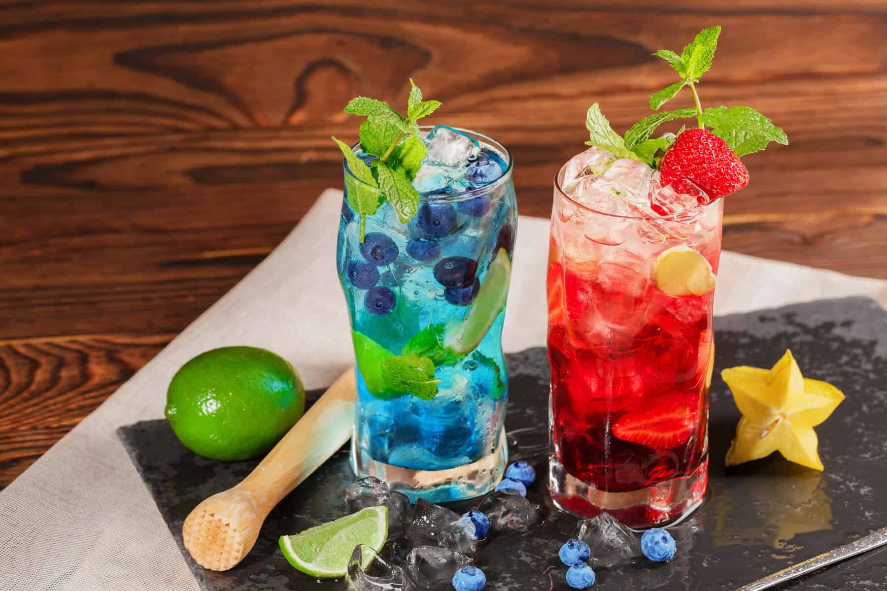 Vibrant summer drink ideas featuring mixed berry cocktails with ice and fruit slices.