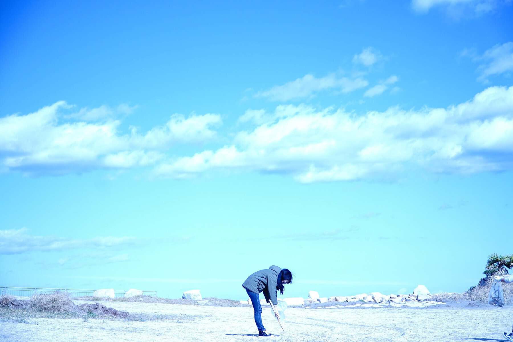 Home Icy 45 Woman playing golf outdoors on a bright day with a blue sky and scattered clouds.