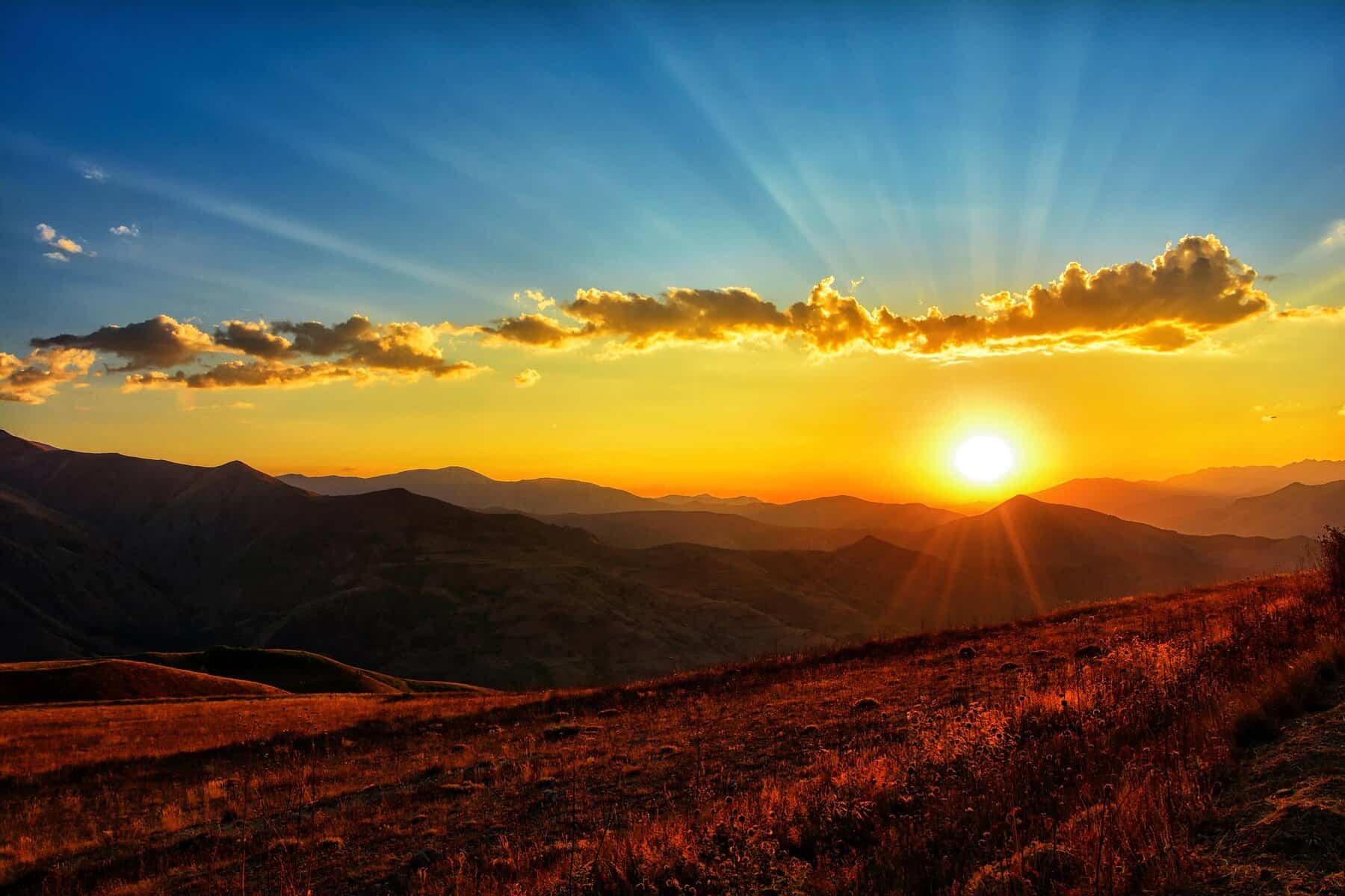 Breathtaking sunset with colorful sky and mountain silhouette, scenic outdoor view.