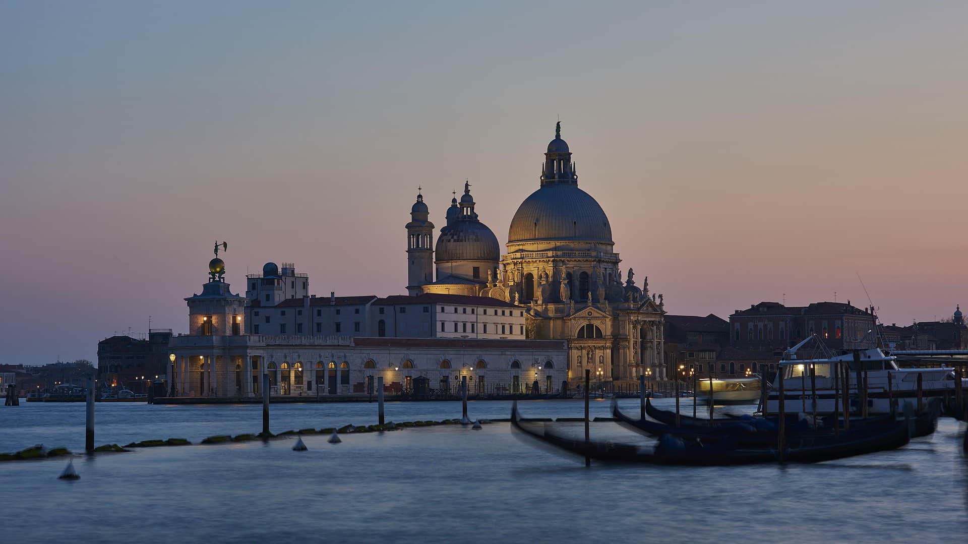 Stunning view of Venice, Italy's iconic cathedral and calm evening waterfront scene.