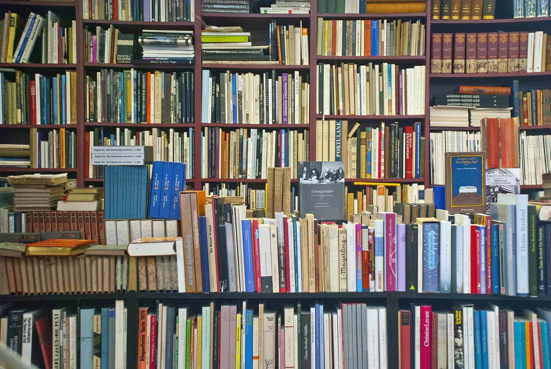 Bookshelf full of diverse books and magazines for reading and study.