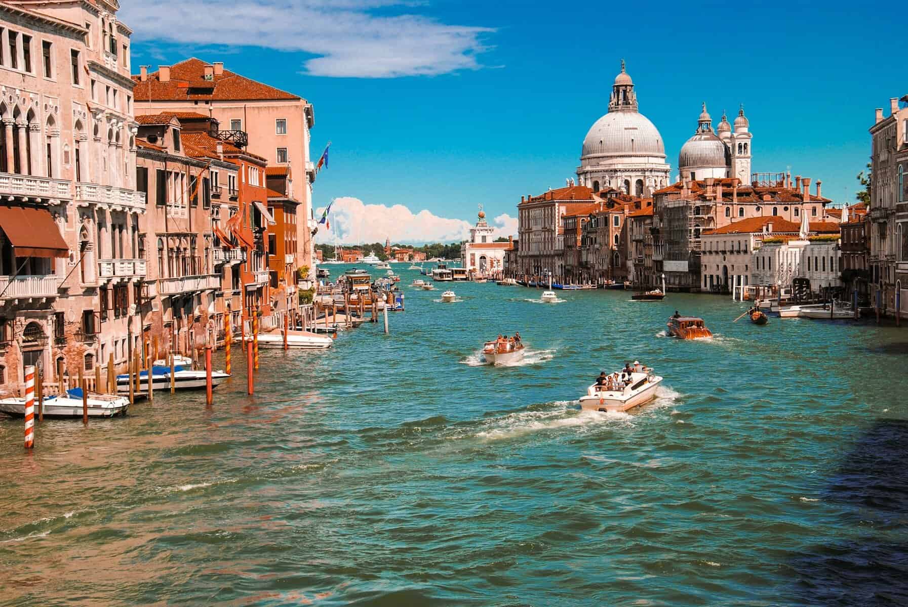 Bright blue sky with boats cruising through the colorful waterway.