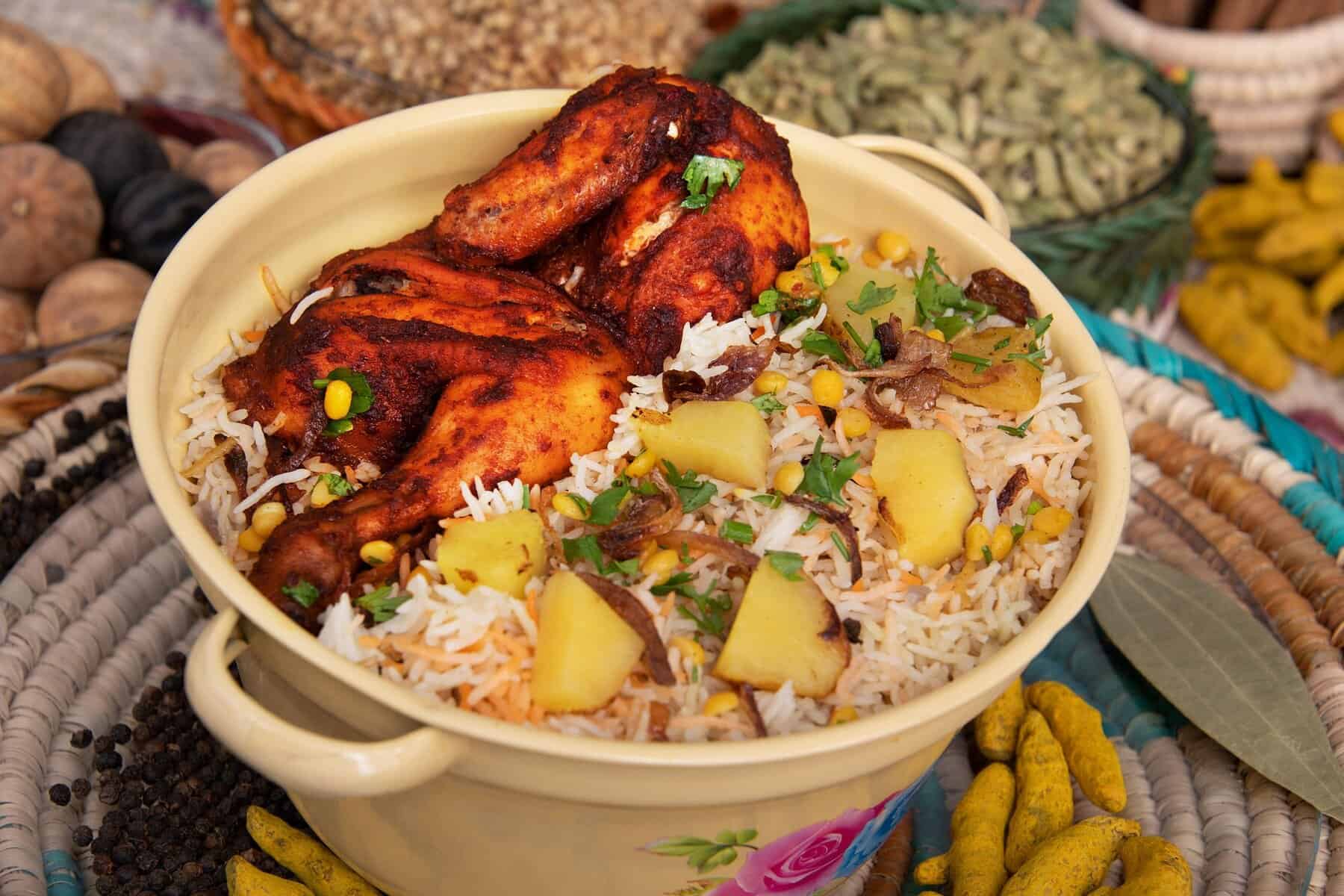 Delicious Indian chicken and rice dish served with potatoes, herbs, and spices.