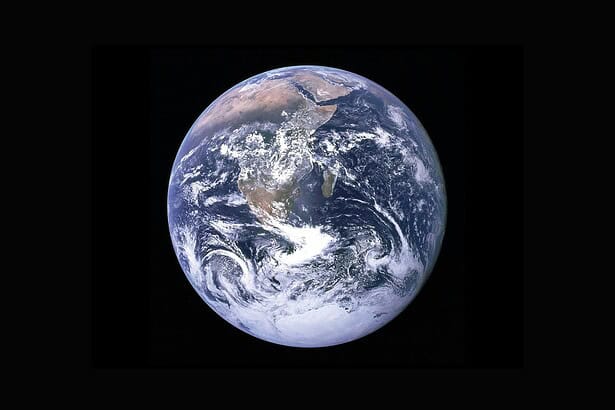 Earth viewed from space highlighting continents and swirling cloud formations.