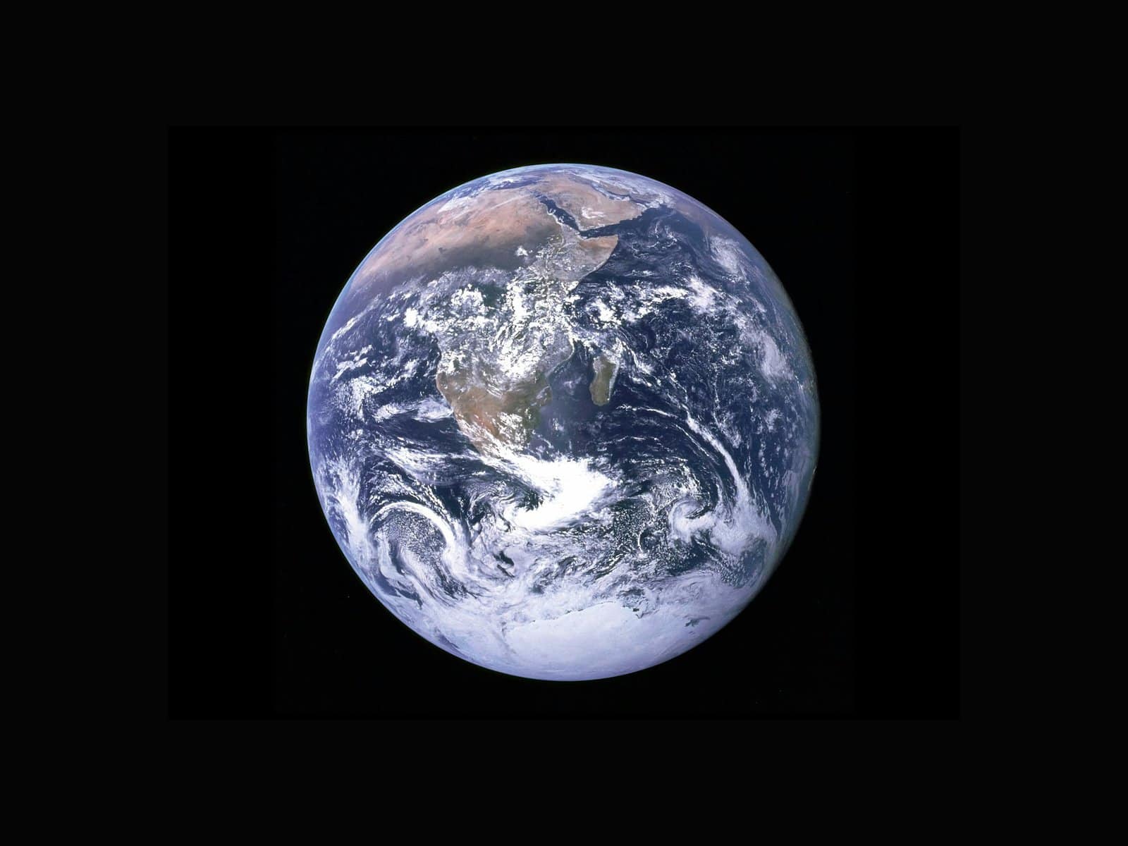Home Icy 43 Earth viewed from space highlighting continents and swirling cloud formations.